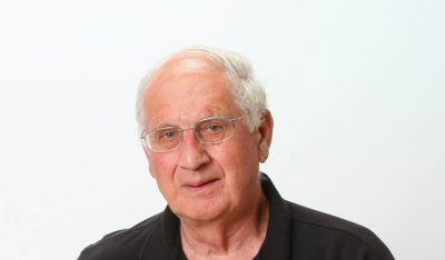 Robert Benoit poses for a photo in a black polo shirt.