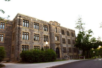 Sandy Hall, home of the Virginia Tech School of Neuroscience, is photographed at dusk with a cloudless sky behind it.